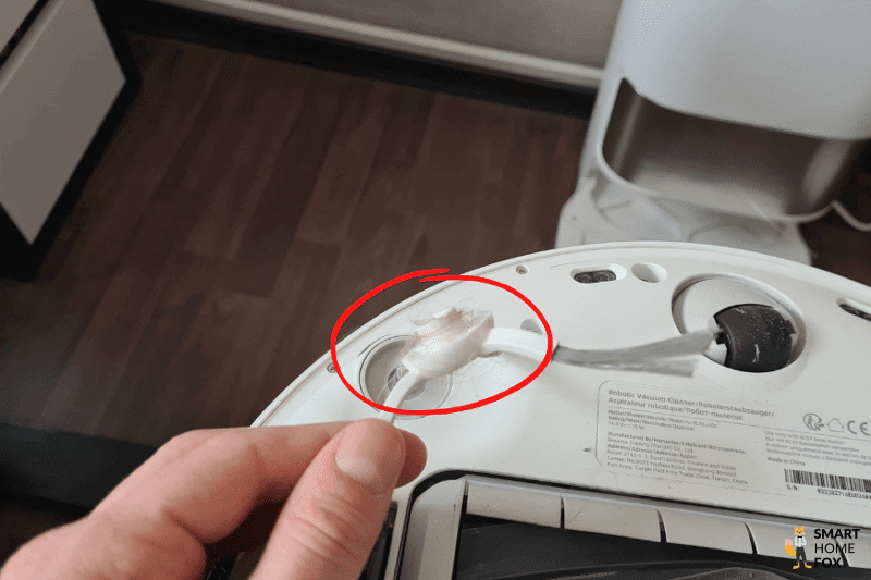 Stuck hairs are removed from the side brush of the Dreame L10s Ultra.